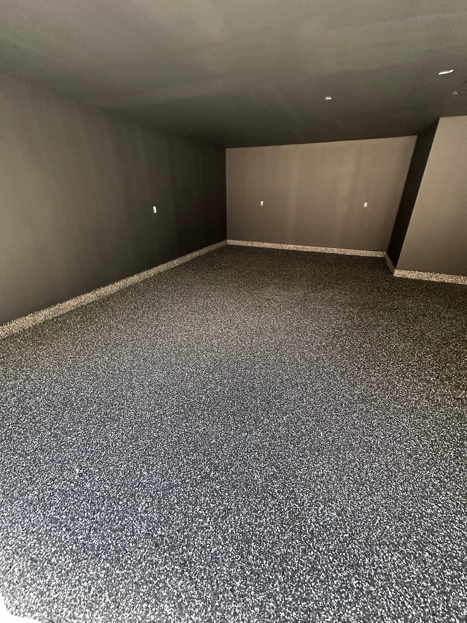 Basement floor coating set against dark walls