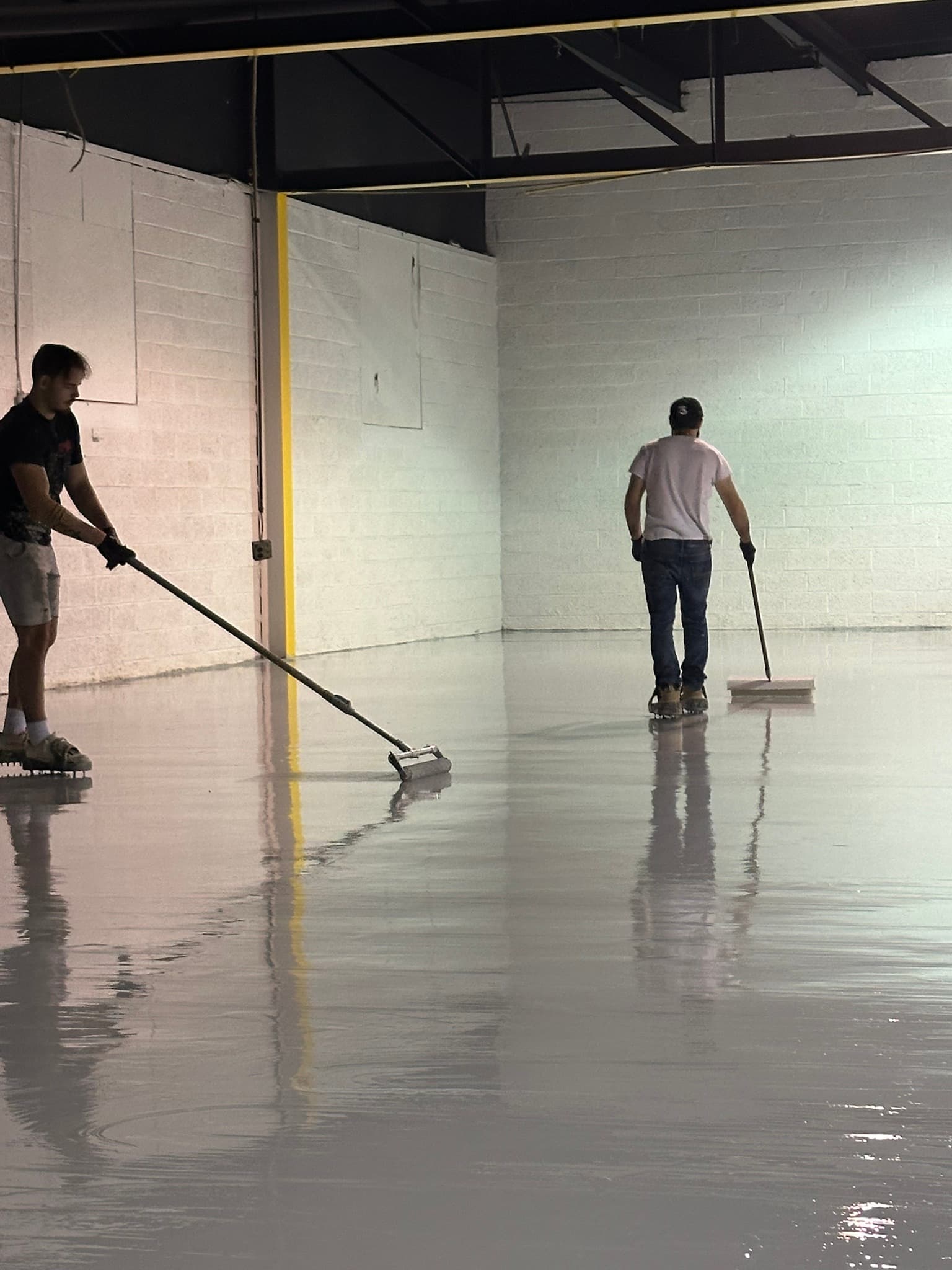 Rolling base coat across a commercial floor