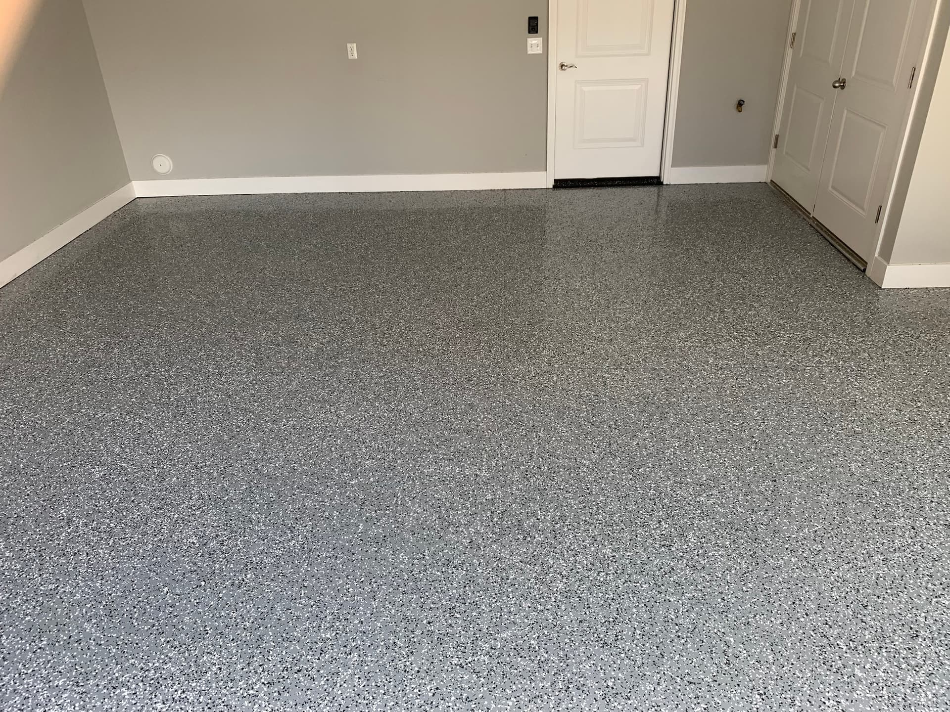 Grey epoxy garage floor with double bay doors