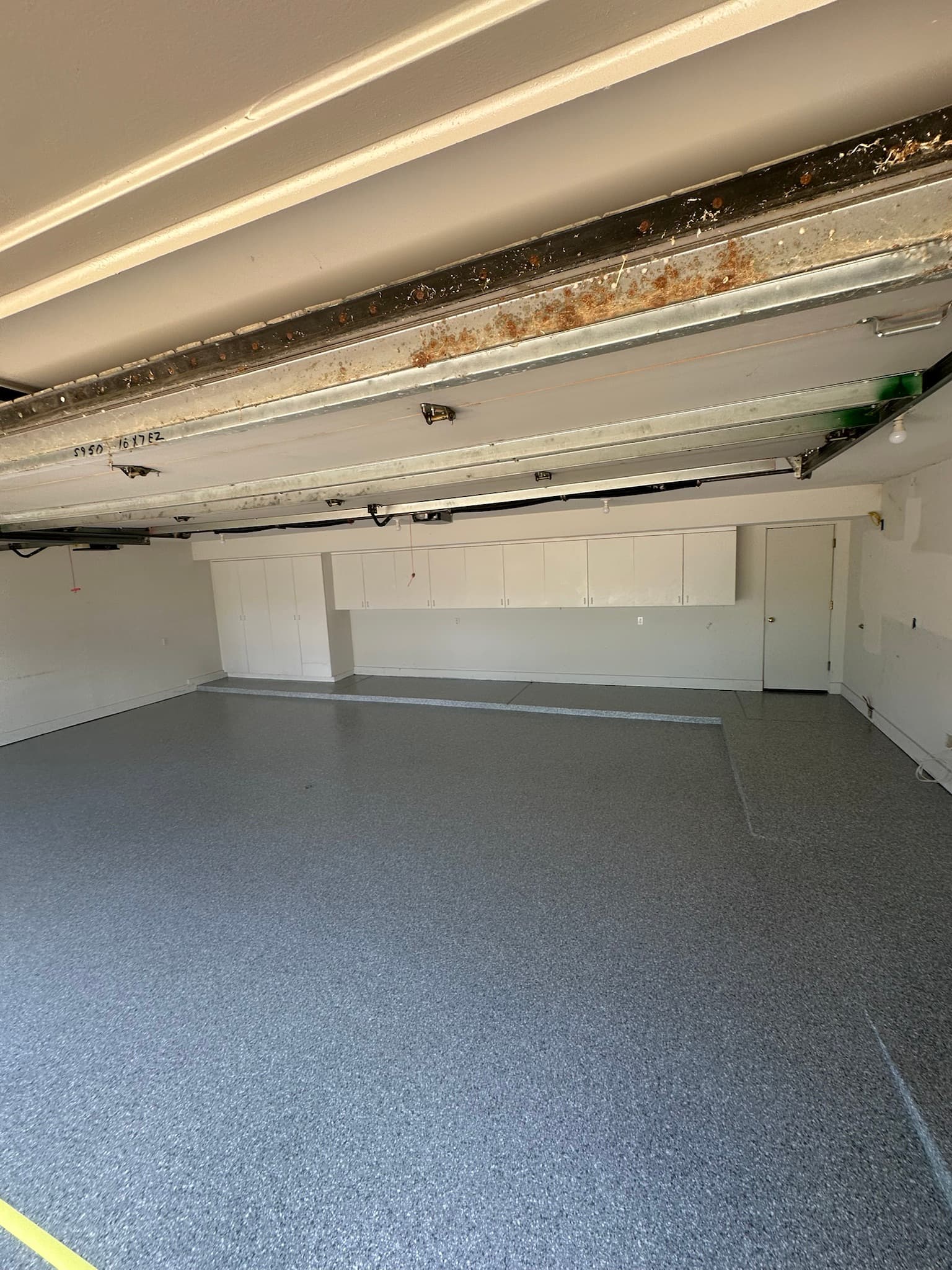 Three-car garage with custom cabinets over a flake floor