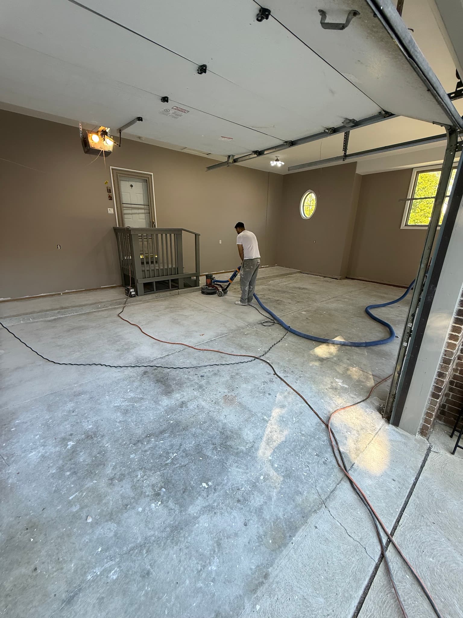 Diamond grinding a garage floor during prep